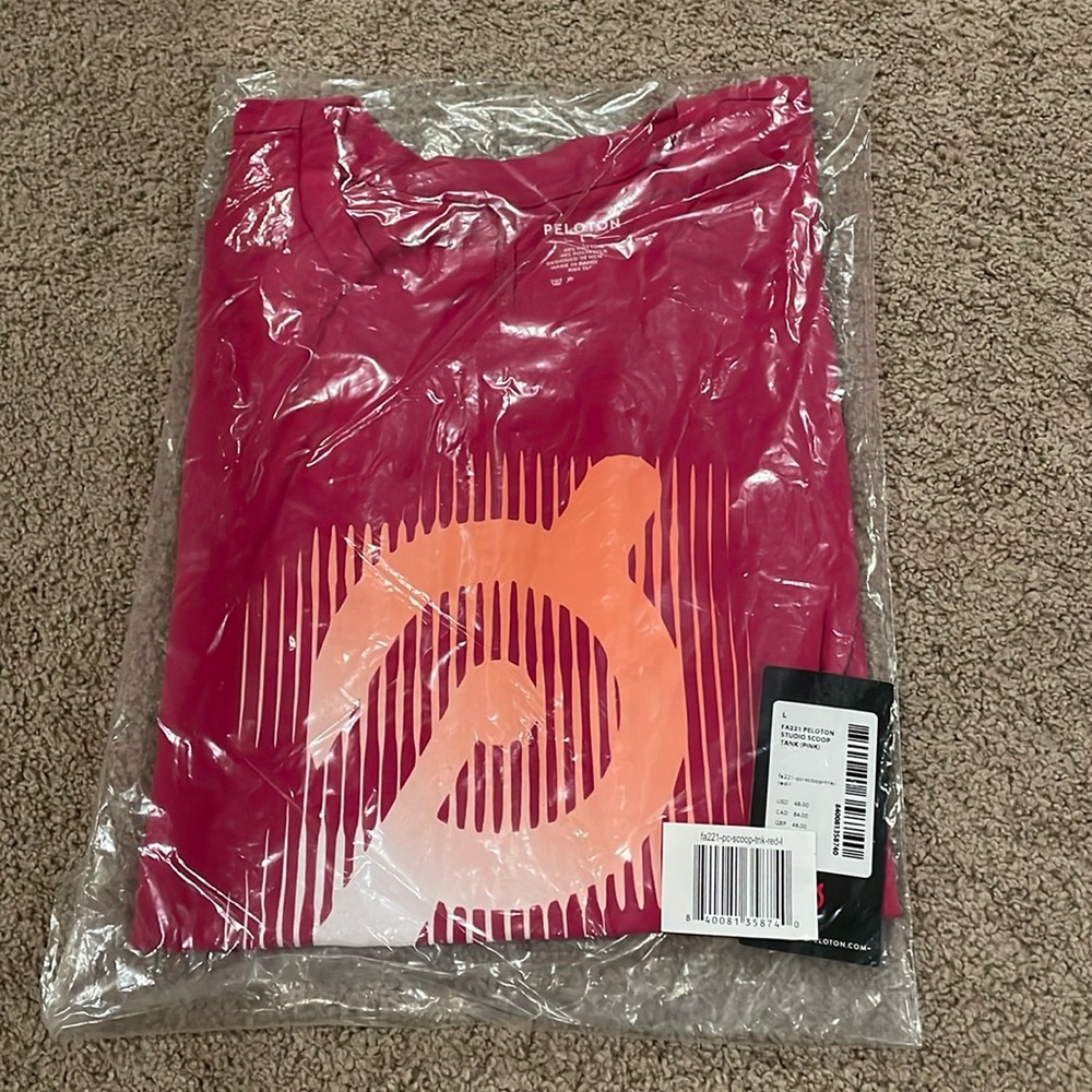 Pink with ombré orange “P” logo Peloton studio scoop tank. NWT in bag.